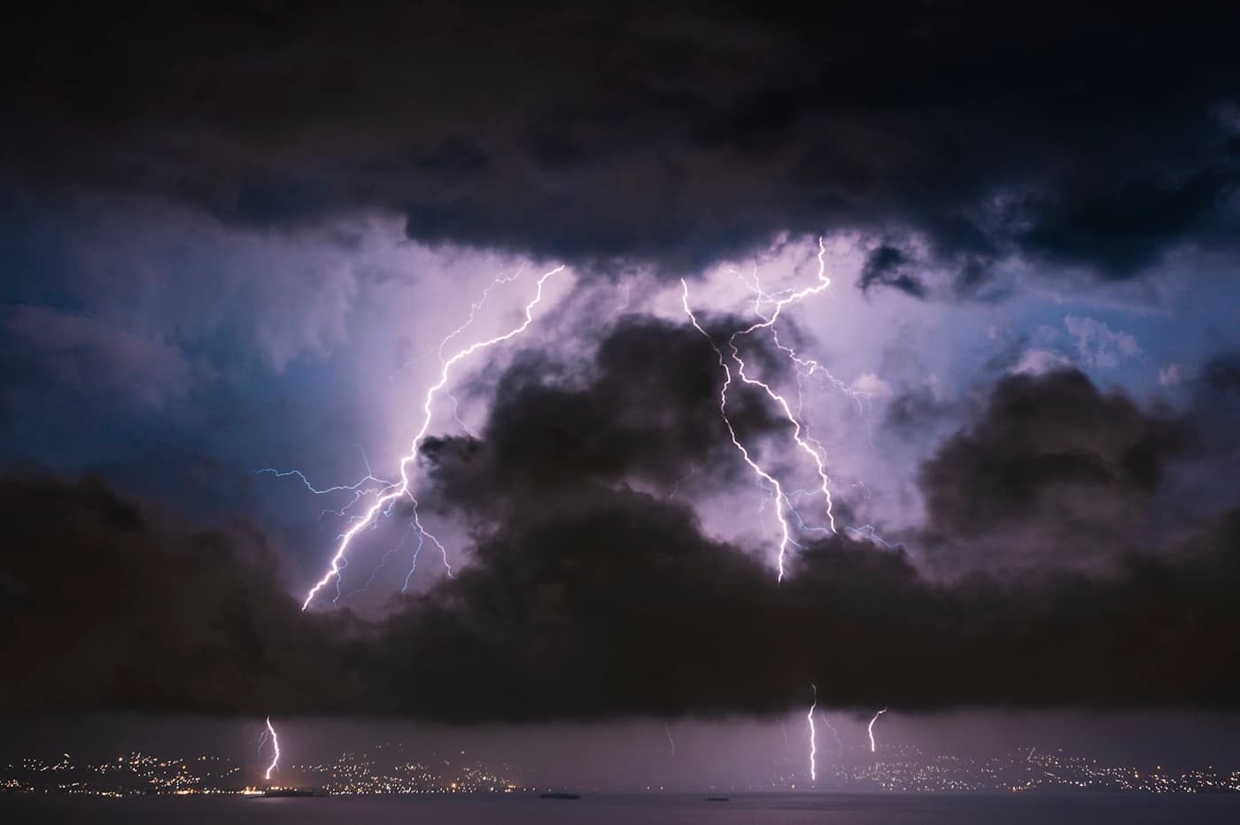 Storm clouds and lightning over a town at night