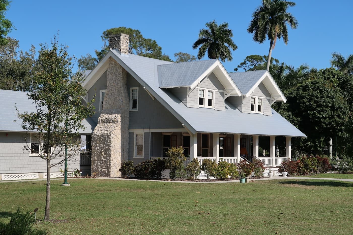 A craftsman-style home with a clean metal roof and dormers