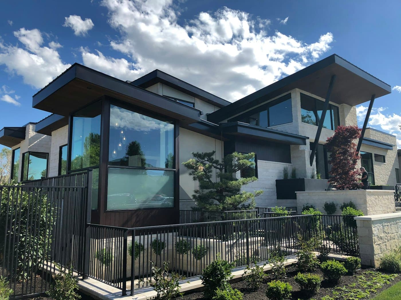 A contemporary home with clean modern rooflines and dark metal-fascia detailing