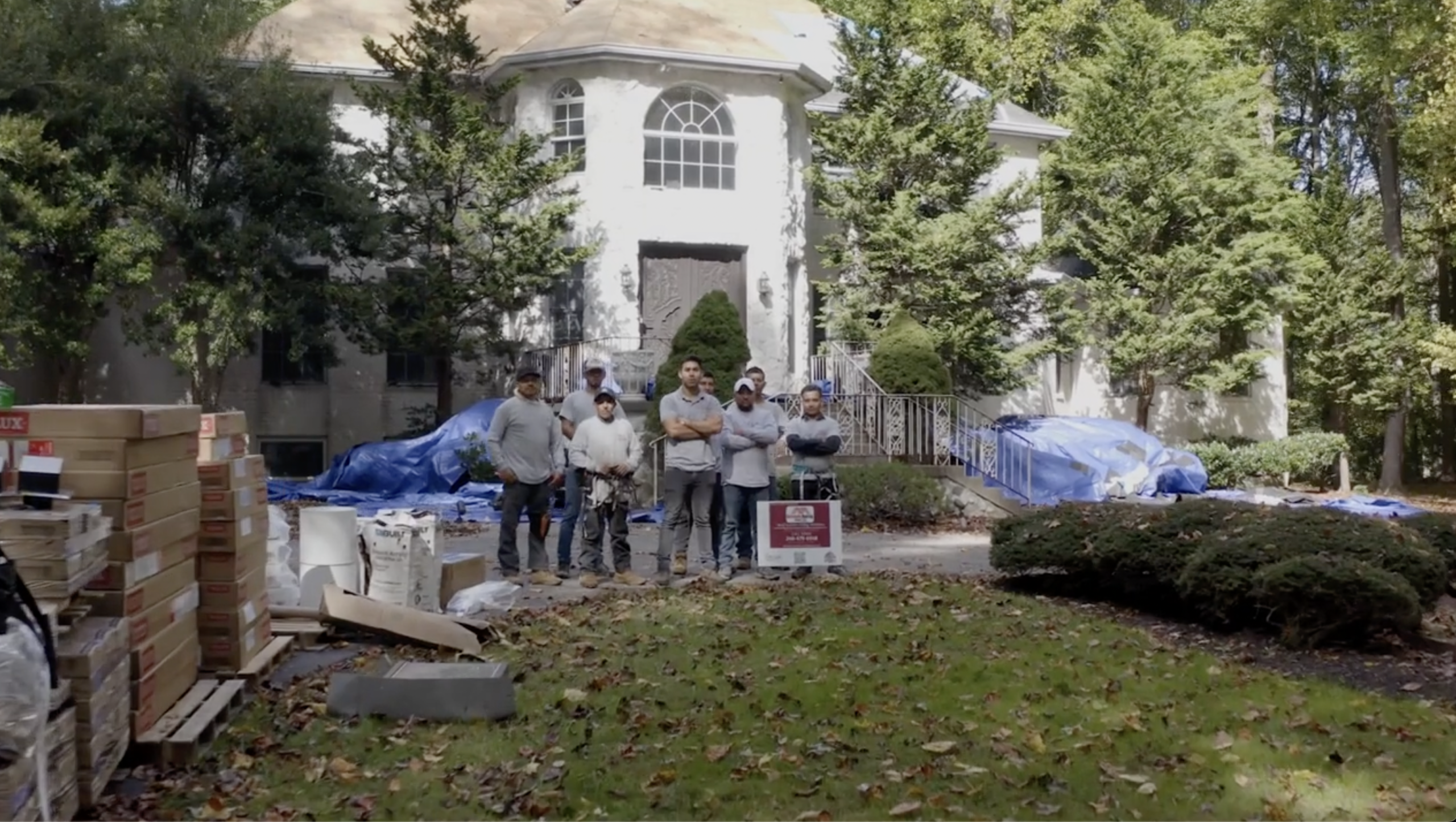 Oakline Roofing Pros crew standing together at a completed roofing job site