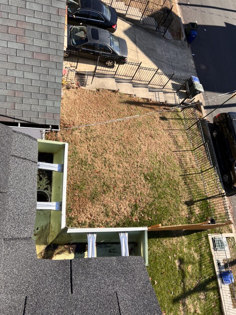 The same gutter valley cleared of debris after cleaning